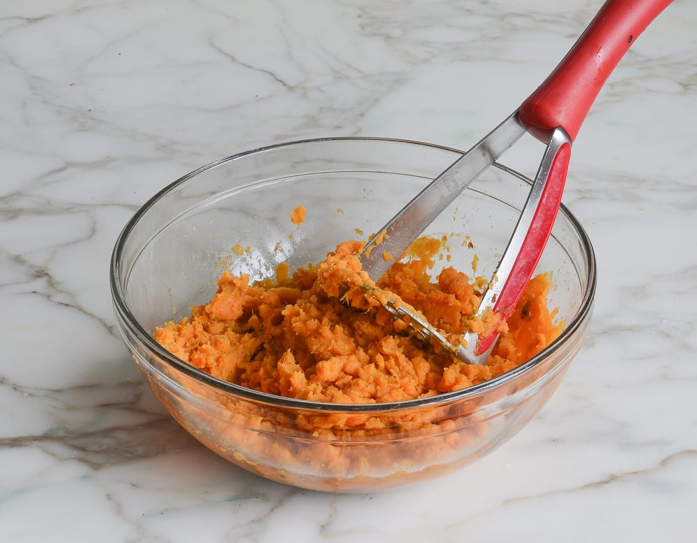 mashing sweet potatoes