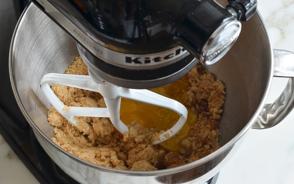adding the egg to mixing bowl