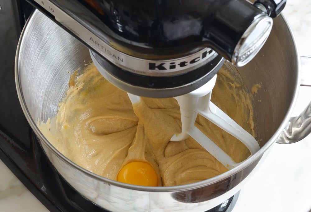 adding the egg yolks one at a time