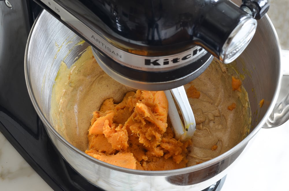 adding mashed sweet potato to mixing bowl