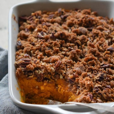 Sweet potato casserole with a scoop missing.