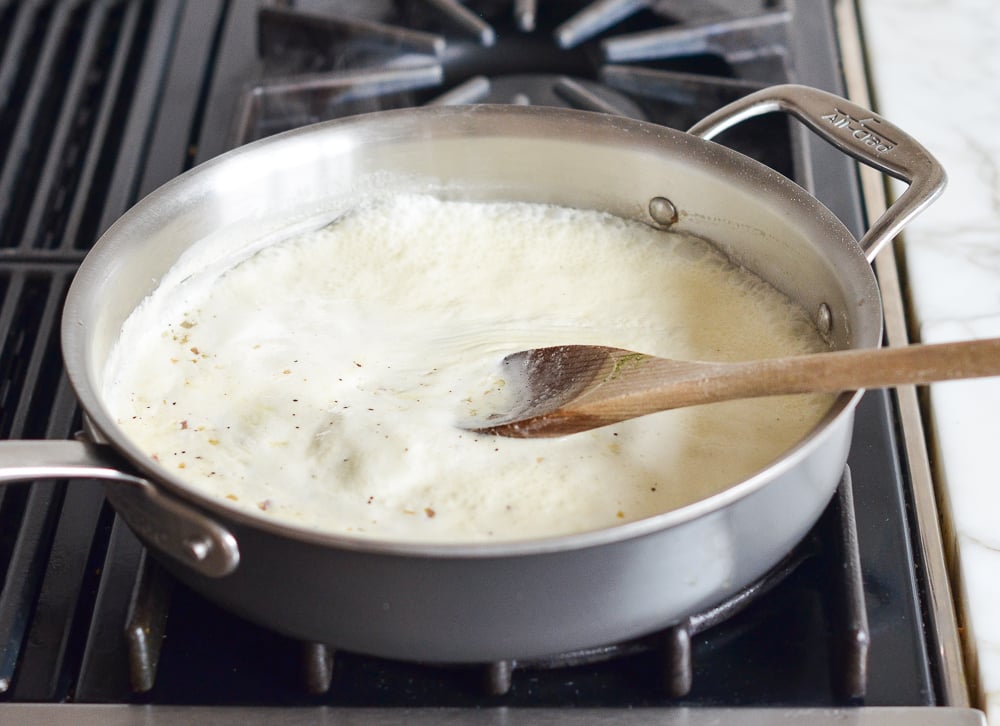Cream boiling in a skillet.