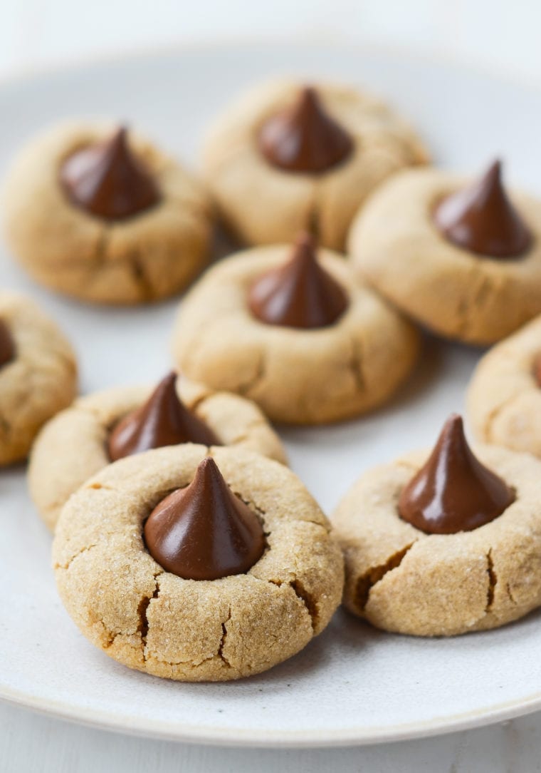 Peanut butter blossoms on parchment paper.