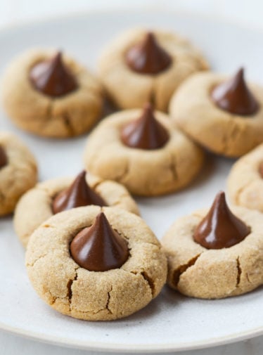 Peanut butter blossoms on parchment paper.
