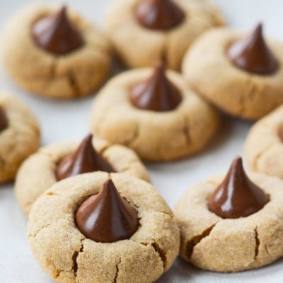 Peanut butter blossoms on parchment paper.