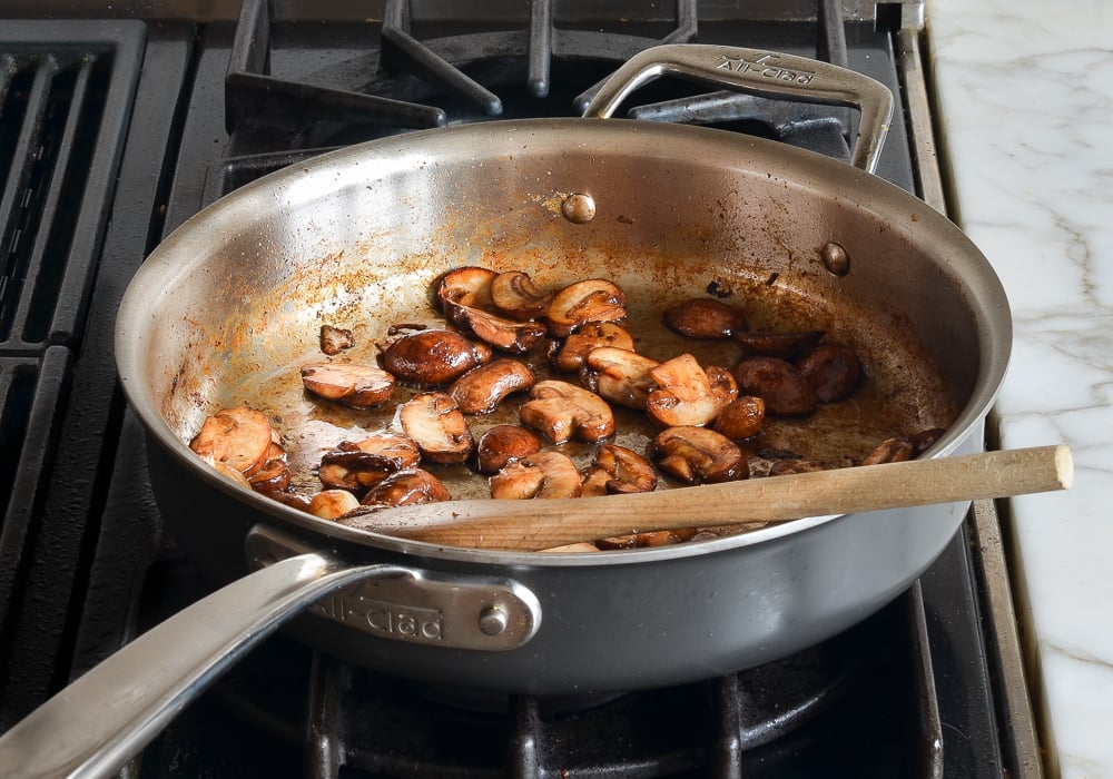 sautéed mushrooms in skillet for coq au vin