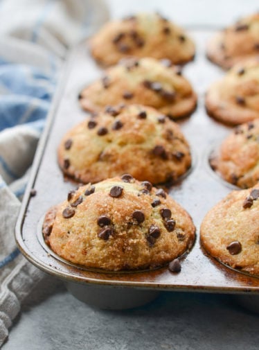 Muffin pan full of chocolate chip muffins.
