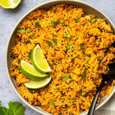 bowl of mexican rice with lime wedges