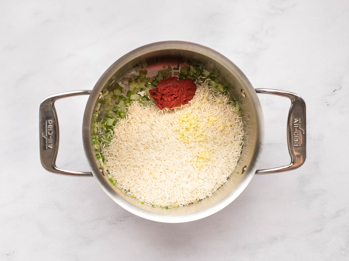 adding the rice and tomato paste