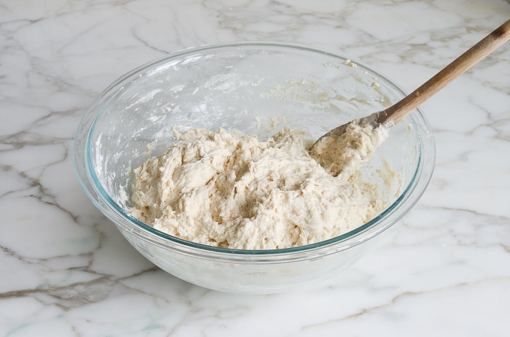 Glass bowl of bread dough.
