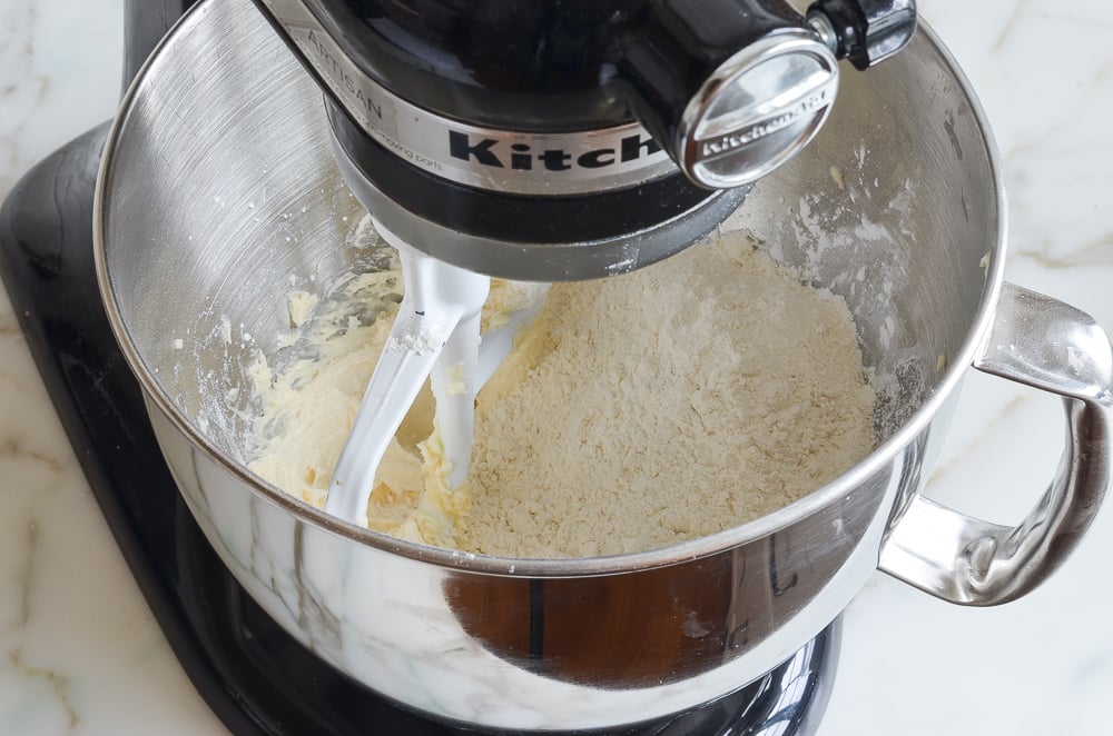Flour added to a stand mixer.