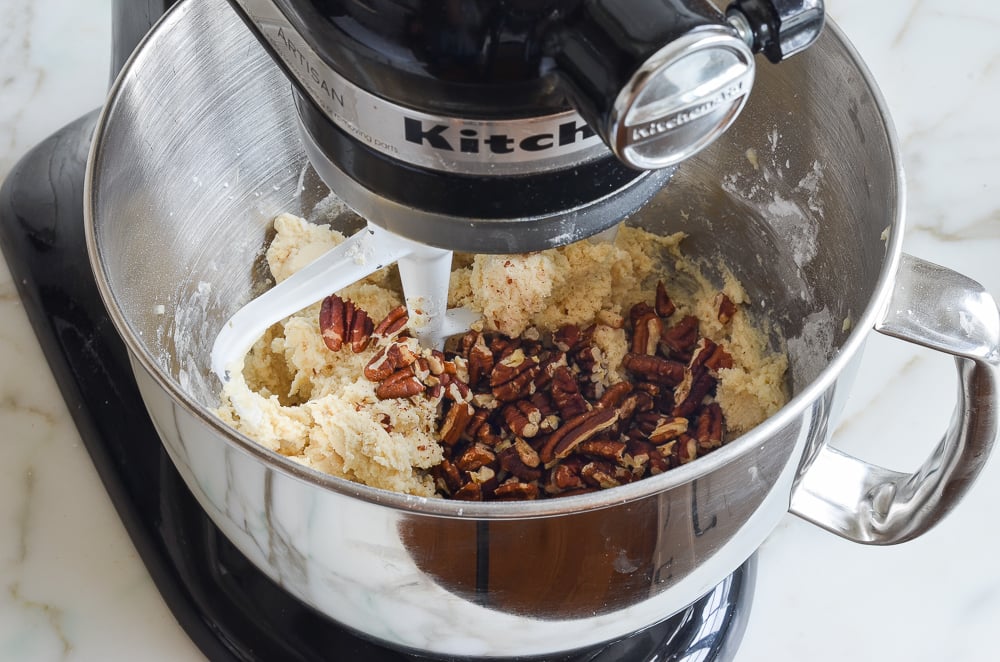 adding the toasted pecans to the dough