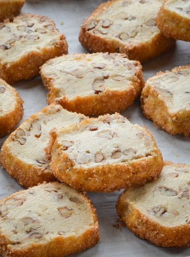 Pecan shortbread cookies on parchment paper.