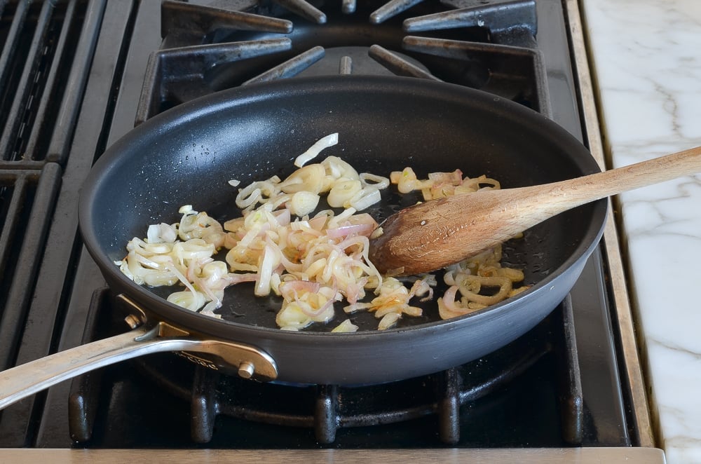 Skillet of softened shallots .