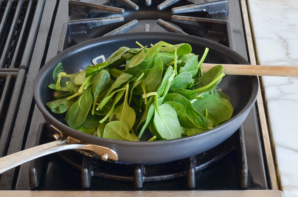 adding the spinach to the shallots