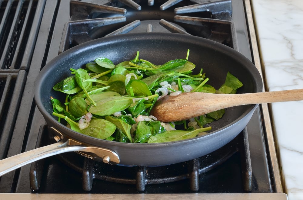 Wilted spinach in a skillet.