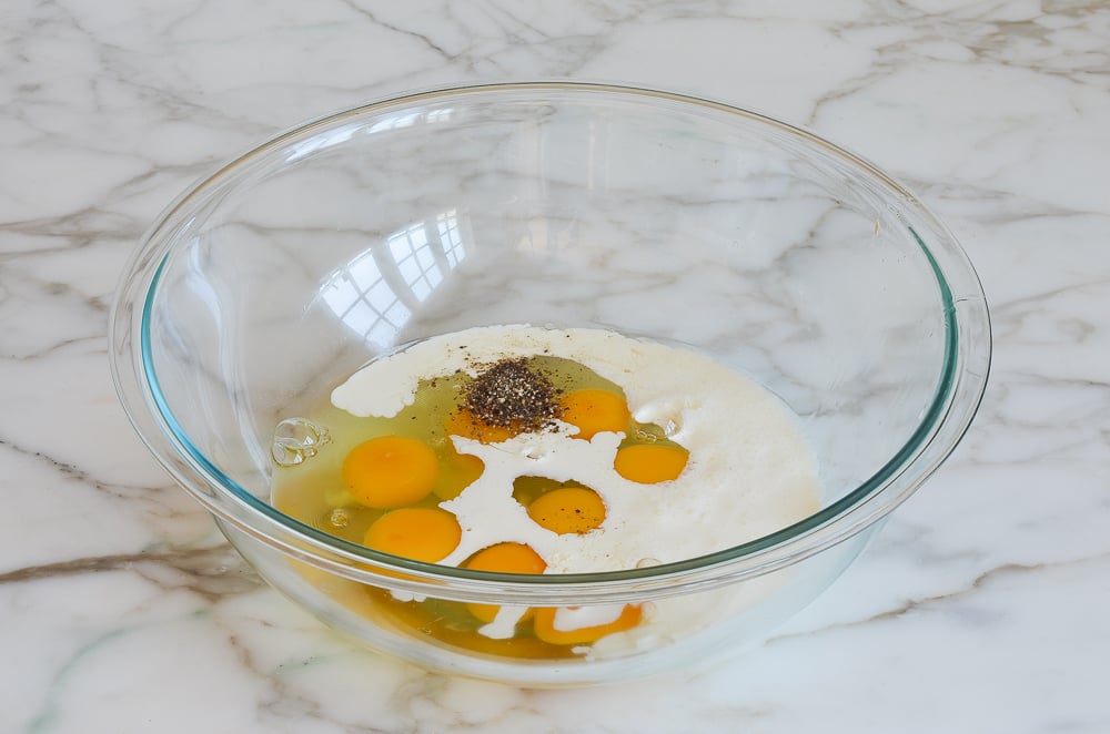 eggs, cream, and seasoning in mixing bowl