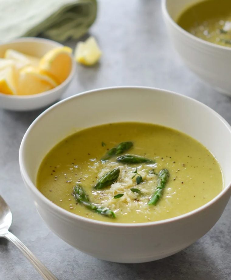 Bowl of asparagus soup with lemon and parmesan.