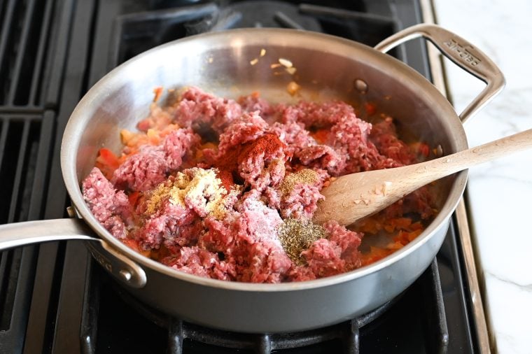 beef and seasoning added to skillet