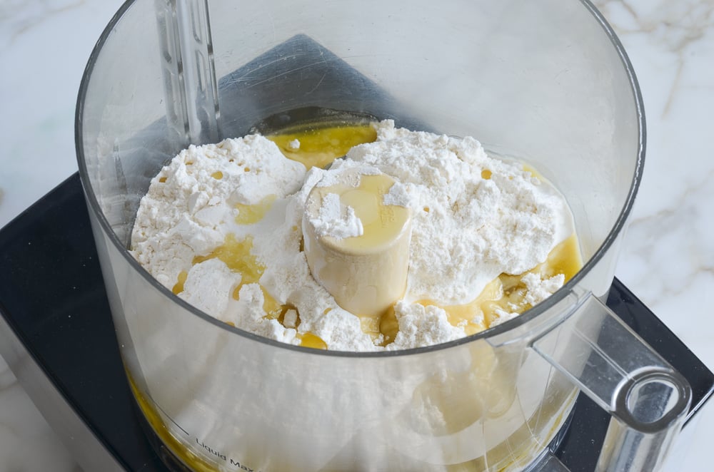 Flour, salt, and olive oil in a food processor.