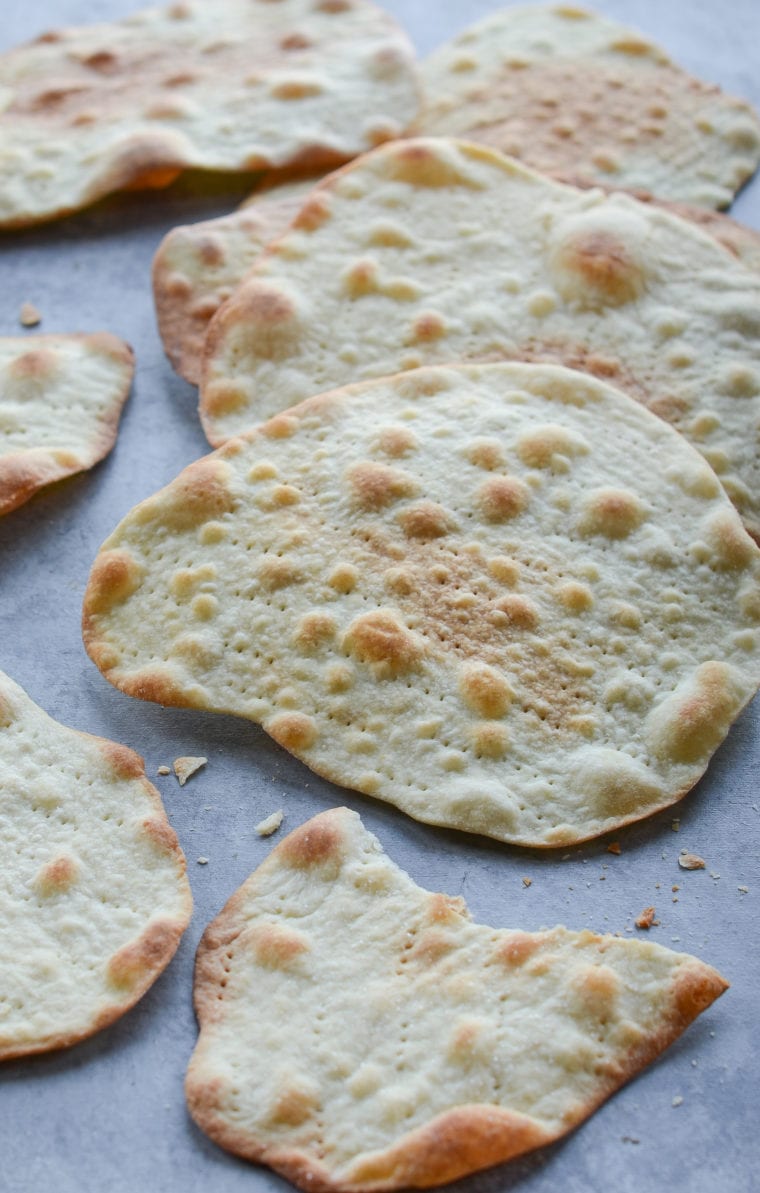 Homemade matzo on parchment paper.