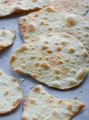 Homemade matzo on parchment paper.