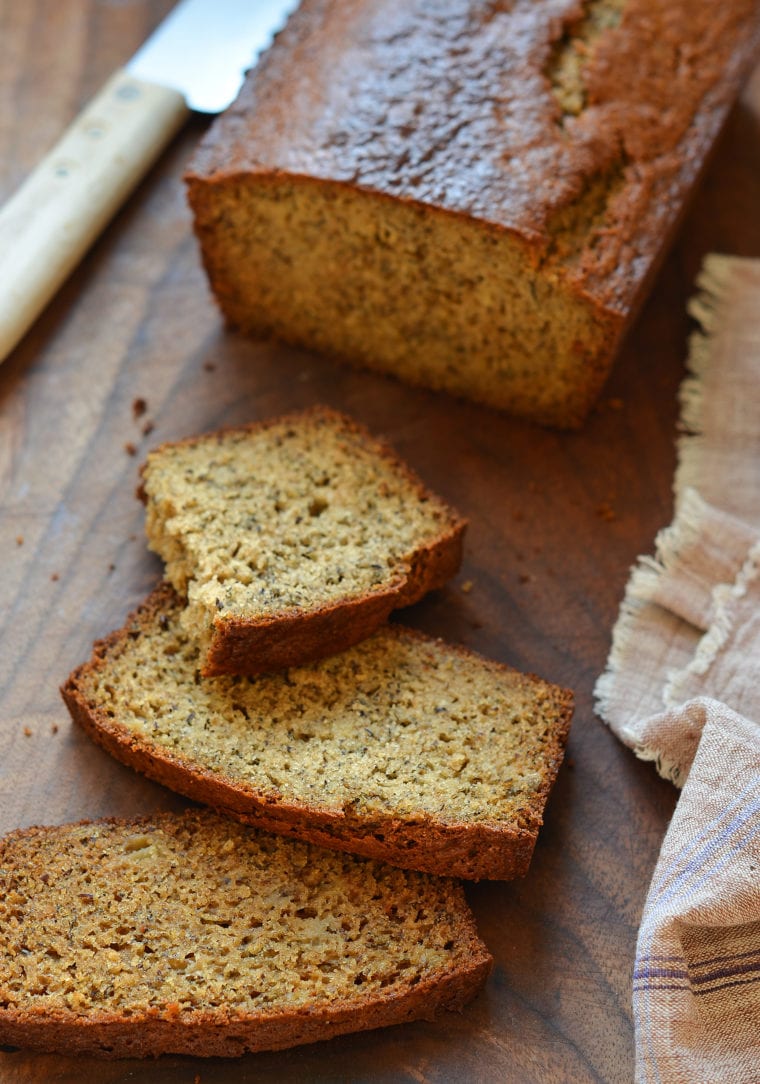 Slices of whole wheat banana bread on a cutting board.