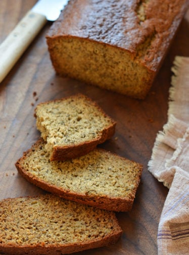 Slices of whole wheat banana bread on a cutting board.