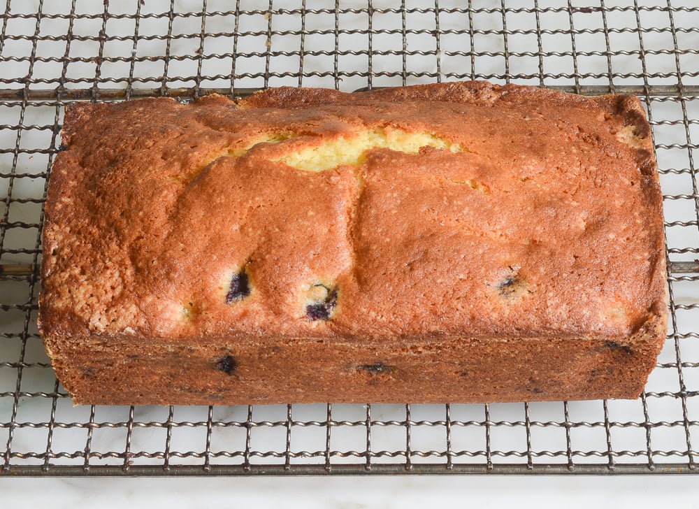 lemon blueberry pound cake cooling on rack
