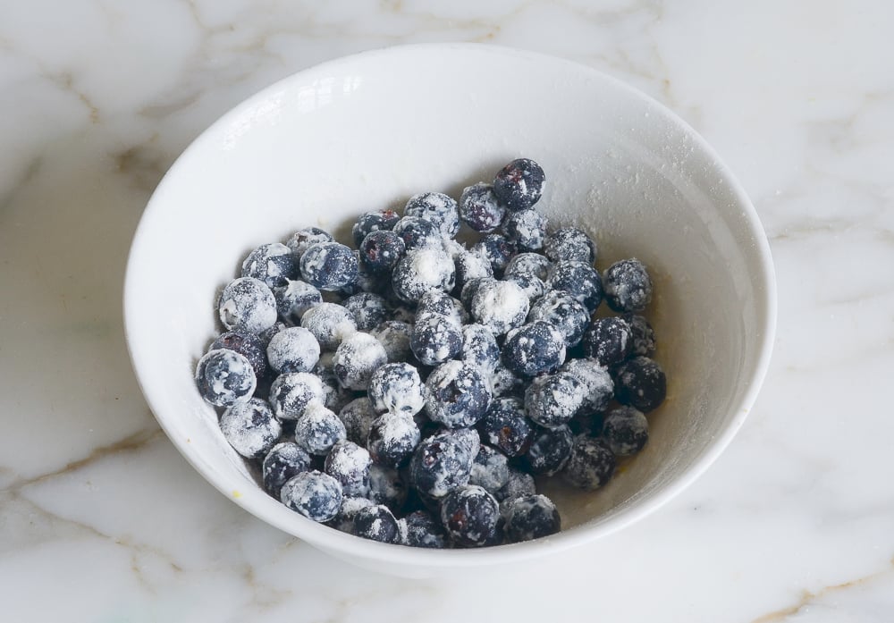 tossing blueberries with flour