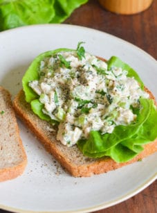 Opened tuna sandwich on a plate.