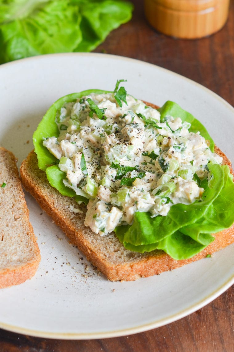 Opened tuna sandwich on a plate.