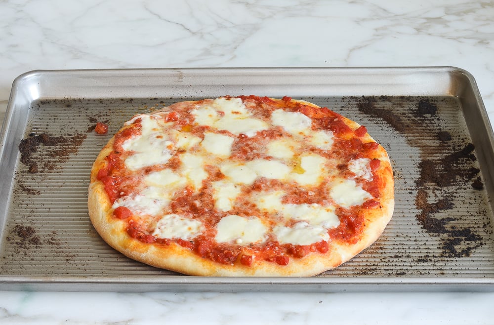 Pizza topped with melted cheese.