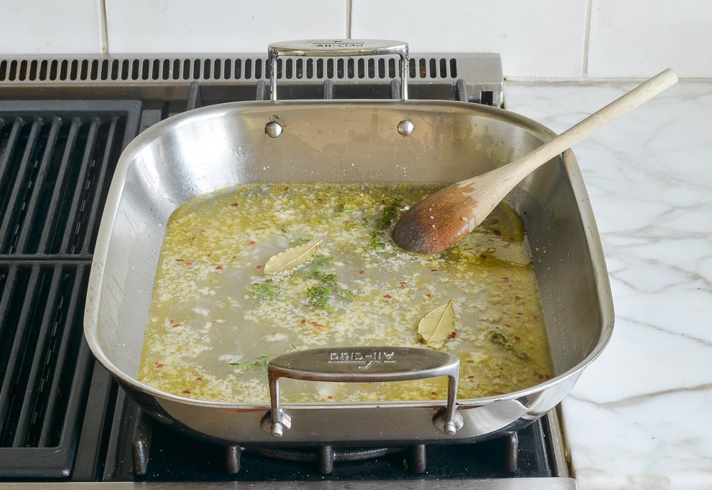 simmering wine, thyme, and bay leaves