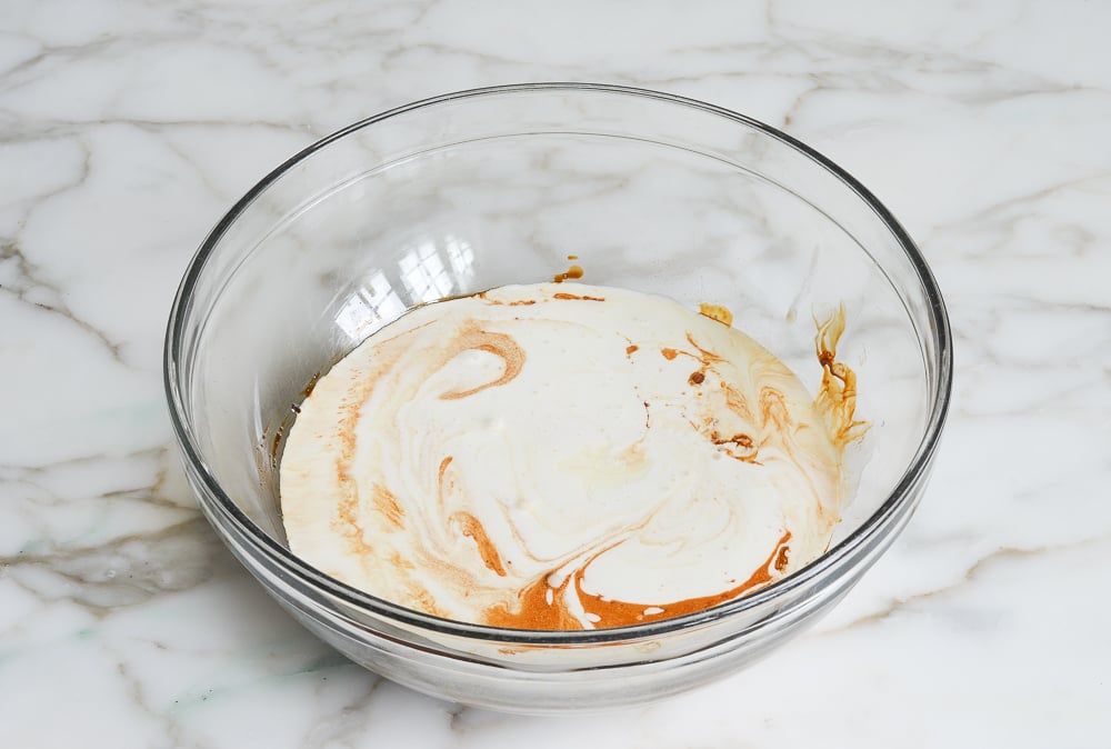 adding cream, sweetened condensed milk, and molasses to the mixing bowl