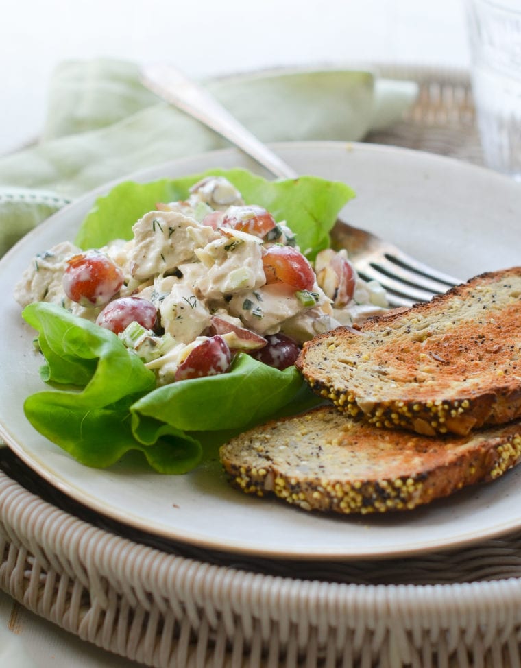 Chicken salad with grapes and almonds on lettuce.