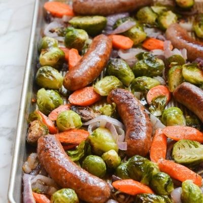 Sheet pan sausage and veggies still on the pan after roasting.