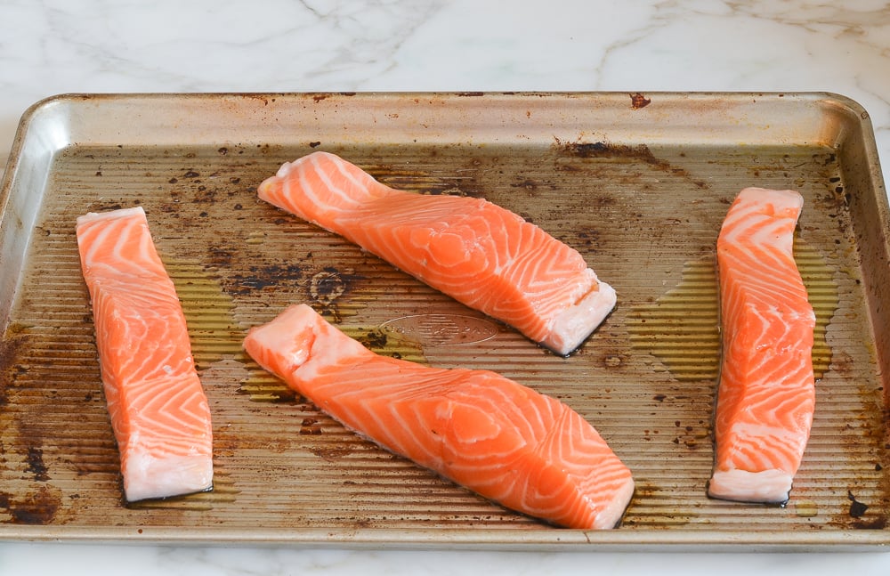 salmon drizzled with oil on sheet pan