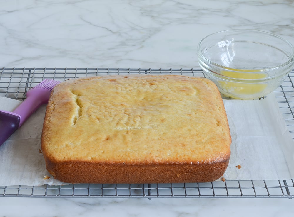 brushing cake with melted butter