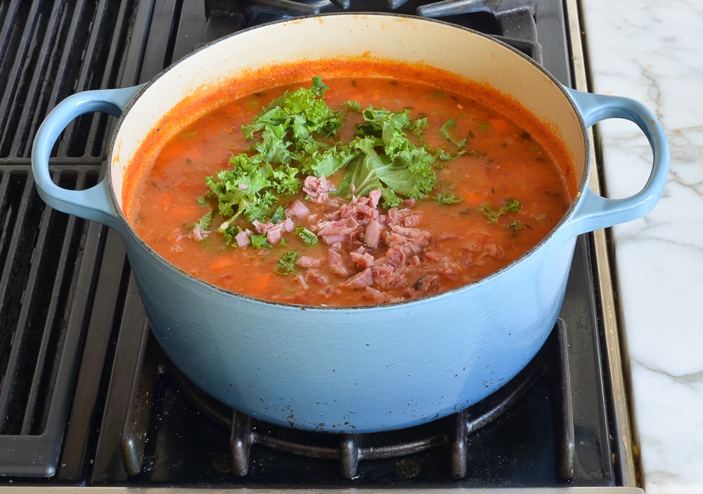 adding greens and ham to soup