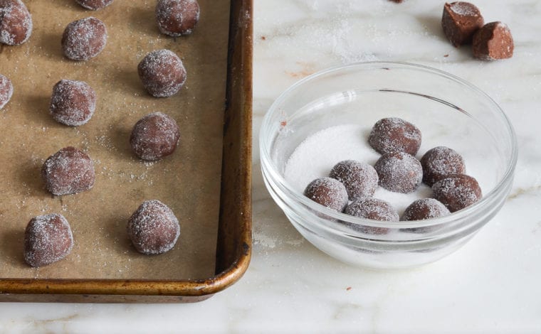 rolling dough balls in sugar