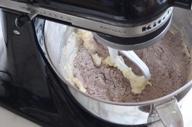adding dry ingredients to cookie dough