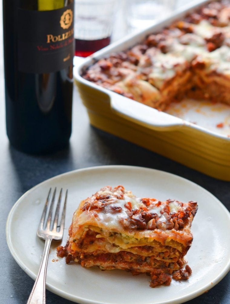 Slice of lasagna on a plate with a fork.