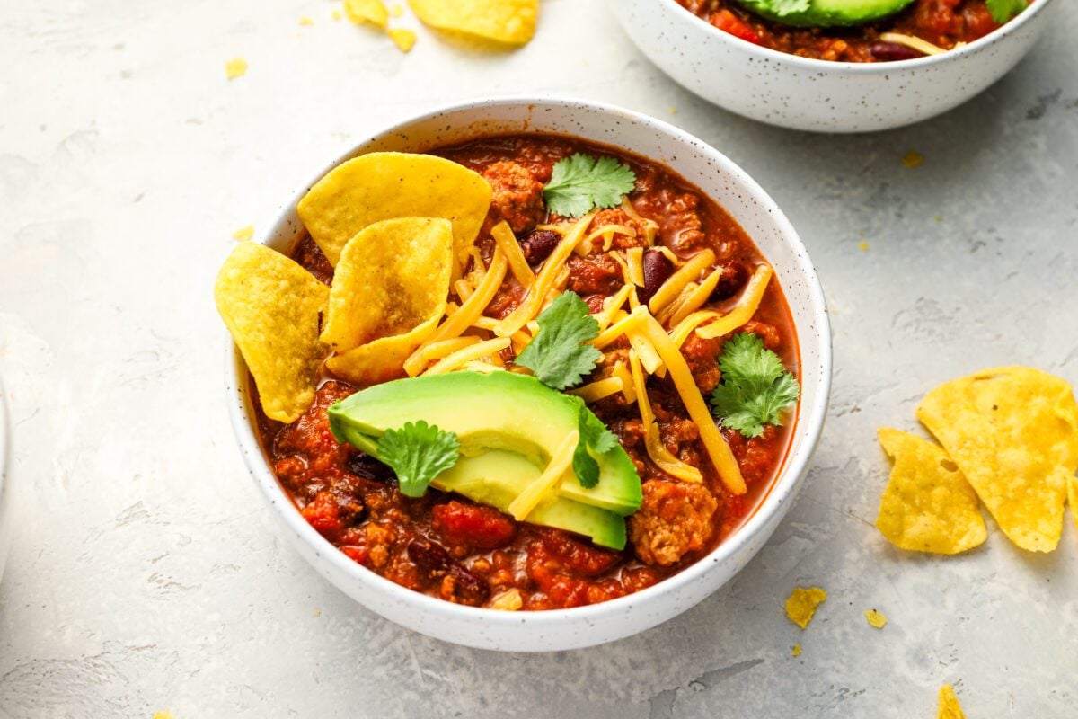 Bowl of turkey chili with all the fixins.