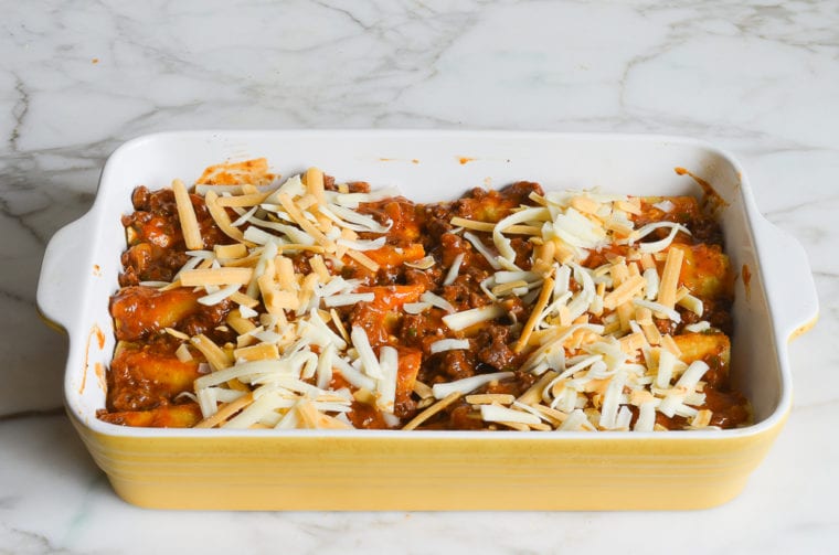 enchiladas covered with sauce and cheese