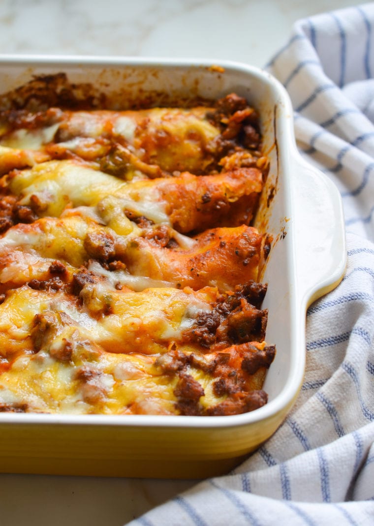 Baking dish of beef enchiladas.