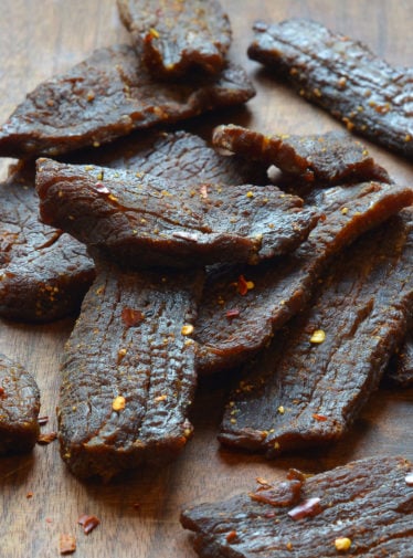 Beef jerky on a wooden surface.