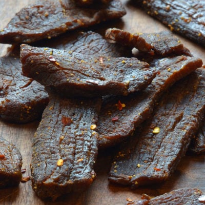 Beef jerky on a wooden surface.