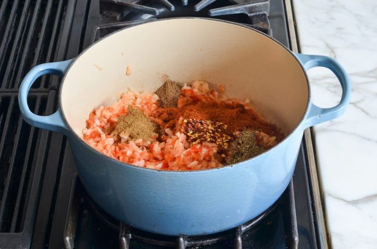 vegetables and spices in Dutch oven.