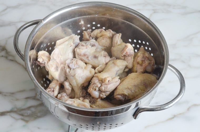 draining the chicken wings.